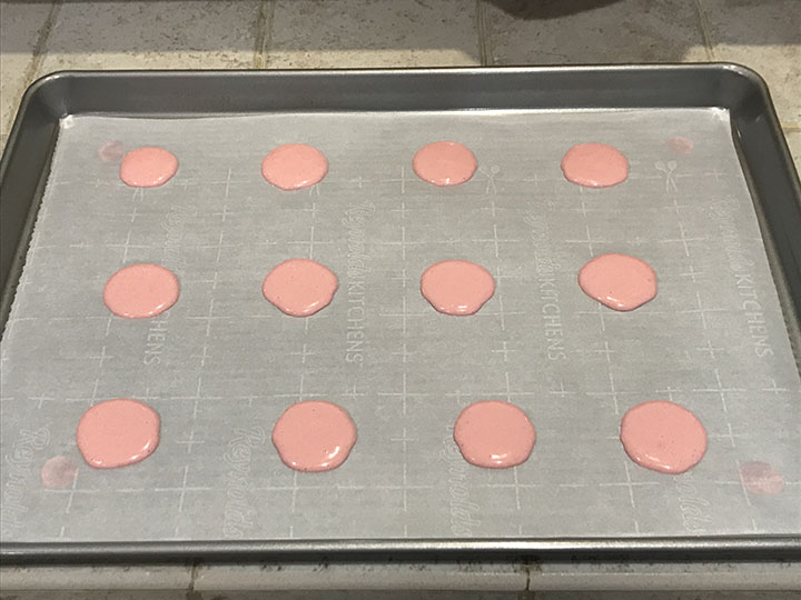 Pink macarons in baking sheet