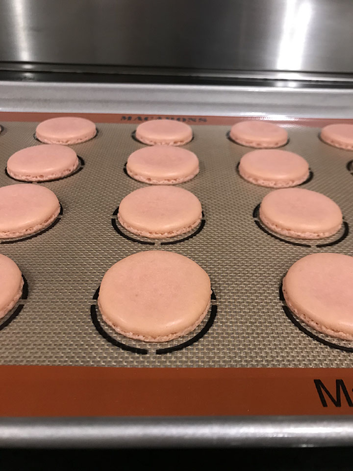 Baked pink macaron shells on silpat