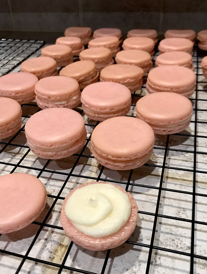 Pink macarons on rack