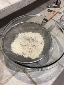 Ground almond flour in sifter